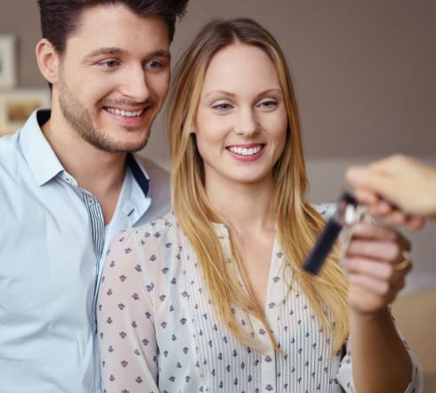 image of a couple receiving a set of keys, they take the key knowing that they are covered by the best Renters' Insurance polcy in Franklin, TN